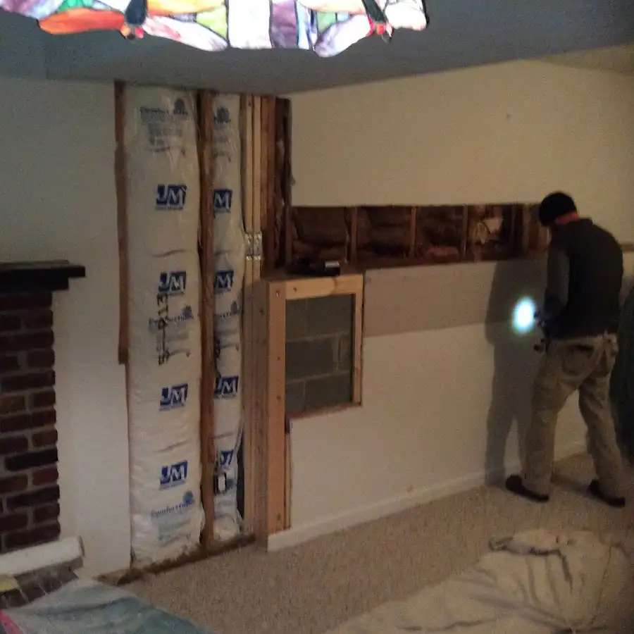Restoration technician inspecting water damage in Cliffside Park